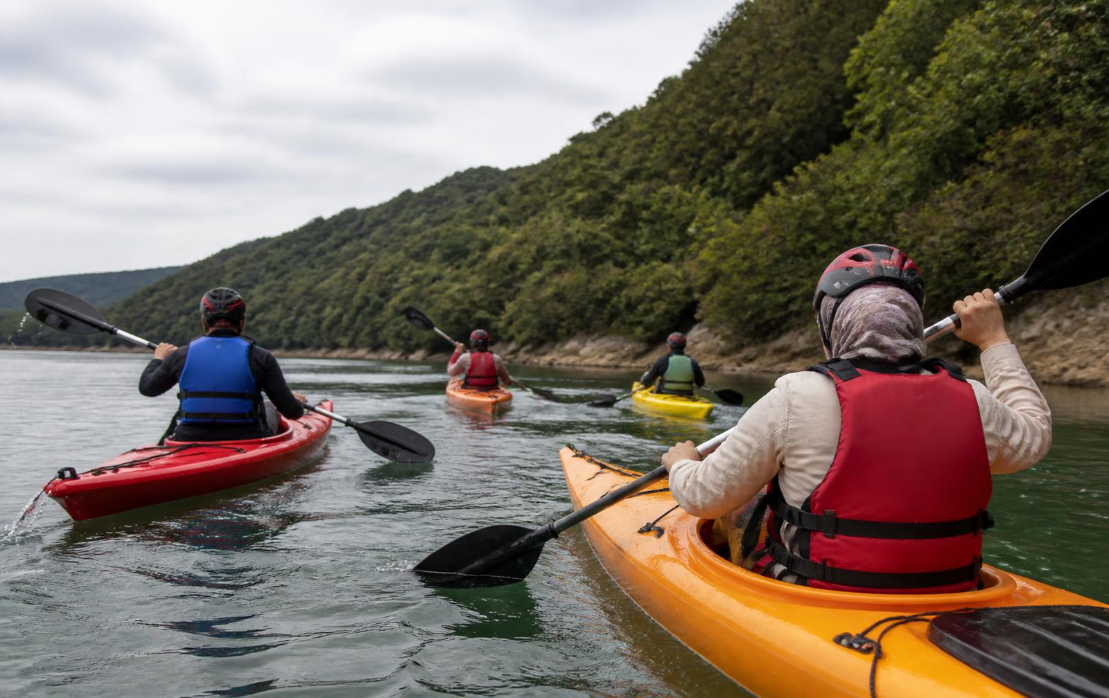 A group enjoying a kayaking activity on open water